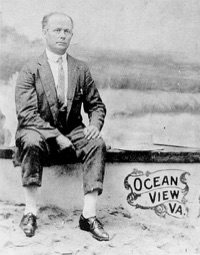 Gilliam Vance Beard seated on a painted seaside backdrop marked Ocean View, Va.